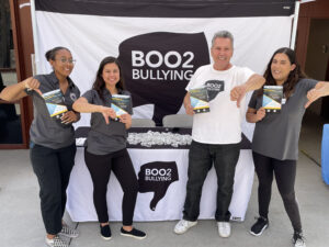 People promoting anti-bullying campaign with flyers.
